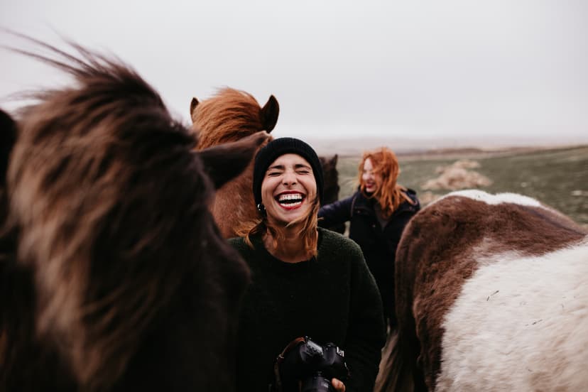 Laughing women with horses