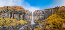 Svartifoss waterfall panorama of black basalt columns between autumn colored nature Svartifoss waterfall panorama of black basalt columns between autumn colored landscape